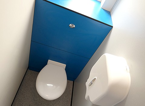 Blue boys toilet cubicle in grammar school