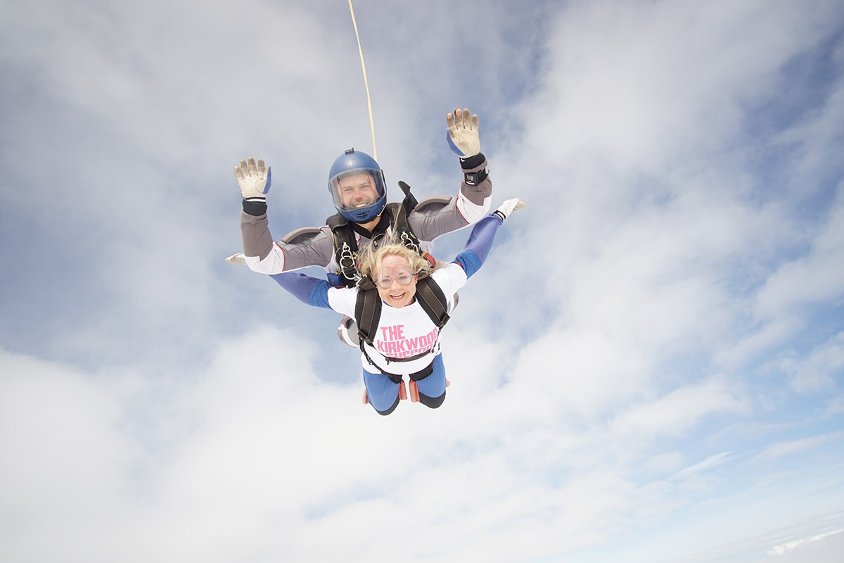 Rachel Skydiving in clear sky Cubicle Centre's Rachel Stanley tandem skydiving in a cloudy sky